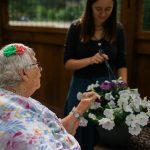 woman in wheelchair enjoying flowers